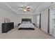 Bedroom features tray ceilings, a ceiling fan, neutral walls, and a plush bed at 3541 Fairstone Rd, Wake Forest, NC 27587