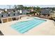 Community pool featuring clear blue water, surrounding seating, and a nearby playground at 3541 Fairstone Rd, Wake Forest, NC 27587