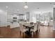 Open concept dining and kitchen area with white cabinets, granite countertops, and stainless steel appliances at 3541 Fairstone Rd, Wake Forest, NC 27587