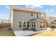 Rear exterior of house with a patio and outdoor seating, surrounded by a green lawn at 3541 Fairstone Rd, Wake Forest, NC 27587