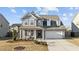 Charming two-story home with a well-manicured front yard and inviting covered porch with a bench at 3541 Fairstone Rd, Wake Forest, NC 27587