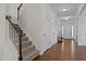 Foyer with staircase, wood floors, white walls, and view of the front door at 3541 Fairstone Rd, Wake Forest, NC 27587