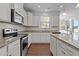 Bright kitchen with modern appliances, granite counters, white cabinets, and ample counter space at 3541 Fairstone Rd, Wake Forest, NC 27587