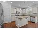 Modern kitchen featuring white cabinets, granite countertops, stainless steel appliances, and a central island at 3541 Fairstone Rd, Wake Forest, NC 27587