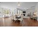Bright living room with wood floors, neutral furniture, fireplace, and lots of windows allowing natural light at 3541 Fairstone Rd, Wake Forest, NC 27587