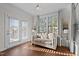 Sitting area with lots of light, french doors, and wood floors with decorative curtains and furniture at 3541 Fairstone Rd, Wake Forest, NC 27587