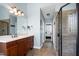 Bathroom featuring a tiled shower, wood cabinets, and an entrance to the primary bedroom at 3655 Pleasants Ridge Dr, Wake Forest, NC 27587