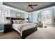 Bright, stylish bedroom featuring a ceiling fan, carpet, and large windows with natural light and blue accent walls at 3655 Pleasants Ridge Dr, Wake Forest, NC 27587