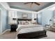 Bright, stylish bedroom featuring a ceiling fan, carpet, and large windows with natural light and blue accent walls at 3655 Pleasants Ridge Dr, Wake Forest, NC 27587