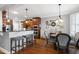 Stylish dining area with hardwood floors, a round table, and bar seating, perfect for gatherings at 3655 Pleasants Ridge Dr, Wake Forest, NC 27587