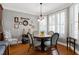 Cozy dining area featuring hardwood floors, a round table, and large windows with natural light at 3655 Pleasants Ridge Dr, Wake Forest, NC 27587