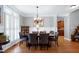 Formal dining room with wainscoting, plantation shutters, and a stylish chandelier at 3655 Pleasants Ridge Dr, Wake Forest, NC 27587