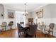 Elegant dining area featuring neutral wall color, dark wood furnishings, and shuttered windows at 3655 Pleasants Ridge Dr, Wake Forest, NC 27587
