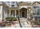 Stunning front entrance with stone accents, a covered porch, and meticulously landscaped surroundings at 3655 Pleasants Ridge Dr, Wake Forest, NC 27587