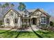 Charming home featuring a stone facade, rocking-chair front porch, and well-manicured lawn at 3655 Pleasants Ridge Dr, Wake Forest, NC 27587