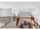 Bright hallway with wooden railing, iron spindles and views of the living spaces below at 3655 Pleasants Ridge Dr, Wake Forest, NC 27587