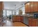 Well-lit kitchen with stainless appliances, wood cabinets, and breakfast nook seating by the window at 3655 Pleasants Ridge Dr, Wake Forest, NC 27587