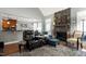 Cozy living room with a stone fireplace, comfortable seating, and hardwood flooring, creating a warm and inviting atmosphere at 3655 Pleasants Ridge Dr, Wake Forest, NC 27587