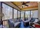 Inviting screened porch with ceiling fan and comfortable seating, overlooking the wooded property at 3655 Pleasants Ridge Dr, Wake Forest, NC 27587