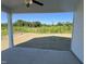 A covered back porch offers views of the grassy backyard and tree line, perfect for outdoor enjoyment at 380 Pecan Valley Way, Four Oaks, NC 27524