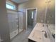 Bright bathroom featuring a glass-enclosed shower and double sink vanity with neutral tones at 380 Pecan Valley Way, Four Oaks, NC 27524