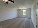 A spacious bedroom provides a serene retreat with natural light from a window and plush carpet flooring at 380 Pecan Valley Way, Four Oaks, NC 27524