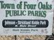Sign for Town of Four Oaks Public Parks including Johnson Strickland Kiddie Park and Holt Kiddie Park at 380 Pecan Valley Way, Four Oaks, NC 27524