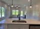 Open-concept kitchen and living area, featuring a center island, and modern appliances at 380 Pecan Valley Way, Four Oaks, NC 27524