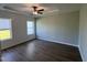 Spacious main bedroom with recessed lighting, hardwood flooring and two bright windows at 380 Pecan Valley Way, Four Oaks, NC 27524