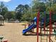 Playground featuring blue slides, climbing structure and wood chip ground covering at 380 Pecan Valley Way, Four Oaks, NC 27524
