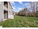 Spacious backyard featuring lush green grass and mature trees, perfect for outdoor relaxation and activities at 4020 Abbey Park Way, Raleigh, NC 27612