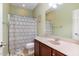 Bathroom with a shower/tub combo with patterned curtain, vanity with a sink, and natural light at 4020 Abbey Park Way, Raleigh, NC 27612