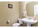 Powder room featuring a pedestal sink, toilet, and framed wall art at 4020 Abbey Park Way, Raleigh, NC 27612