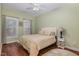 Cozy bedroom with a comfortable bed, wood floors, ceiling fan, and two windows for natural light at 4020 Abbey Park Way, Raleigh, NC 27612