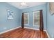 Well-lit bedroom featuring laminate floors, two large windows, and neutral-toned walls for a comfortable feel at 4020 Abbey Park Way, Raleigh, NC 27612