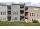 Townhome features multi-level balconies and a well-maintained lawn with a private backyard area at 4020 Abbey Park Way, Raleigh, NC 27612