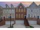 Townhomes feature brick accents, garages, and inviting entrances; a well-maintained community at 4020 Abbey Park Way, Raleigh, NC 27612