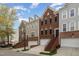 View of multiple home exteriors featuring brick and siding, private entries, and manicured landscaping at 4020 Abbey Park Way, Raleigh, NC 27612