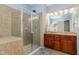 Main bathroom features a glass shower, double sink vanity, and tile floors for a luxurious feel at 4020 Abbey Park Way, Raleigh, NC 27612