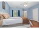 Main bedroom showcasing a bed with built in drawers, hardwood floors and a window with lots of natural light at 4020 Abbey Park Way, Raleigh, NC 27612