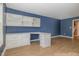 Stylish home office with custom built-in desk, drawers, cabinets, and new laminate flooring at 4020 Abbey Park Way, Raleigh, NC 27612