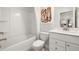 Bathroom featuring a tub and shower combination, a white vanity, and clean, bright lighting at 408 Providence Spring Ln, Fuquay Varina, NC 27526