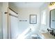 Bathroom showcasing a shower with curtain, framed art and a vanity near a window providing natural light at 48 Blue Heron Ln, Roxboro, NC 27574