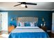 This bedroom features a large bed, attractive lighting, and an accent wall at 48 Blue Heron Ln, Roxboro, NC 27574