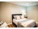 Cozy bedroom with a queen bed, decorative pillows, and wood laminate flooring at 48 Blue Heron Ln, Roxboro, NC 27574