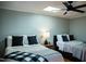 Comfortable bedroom featuring two beds, a ceiling fan, and ample natural light offering a peaceful retreat at 48 Blue Heron Ln, Roxboro, NC 27574