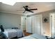 Bright bedroom features two beds, a ceiling fan, and closet space, providing comfort and functionality at 48 Blue Heron Ln, Roxboro, NC 27574