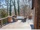 The home's deck provides ample seating and a view of the surrounding trees and lake at 48 Blue Heron Ln, Roxboro, NC 27574