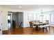Bright dining room featuring wood floors, large windows, and a spacious table with bench seating at 48 Blue Heron Ln, Roxboro, NC 27574