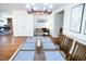 Well-lit dining room with a large table and hardwood floors, next to living room at 48 Blue Heron Ln, Roxboro, NC 27574